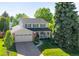 Charming two-story home featuring a manicured lawn, mature trees, and a cozy front porch with great curb appeal at 6829 S Niagara Ct, Centennial, CO 80112