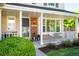 Inviting front porch with white railings, decorative lanterns, and a cozy seating area for relaxing outdoors at 6829 S Niagara Ct, Centennial, CO 80112