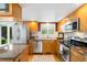 Bright kitchen features stainless steel appliances, granite countertops, and hardwood floors at 6829 S Niagara Ct, Centennial, CO 80112