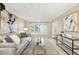 Elegant living room featuring a comfortable sofa, stylish decor, and ample natural light from large windows at 6829 S Niagara Ct, Centennial, CO 80112