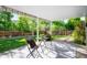 Covered patio with seating and view of landscaped backyard with lush greenery at 6829 S Niagara Ct, Centennial, CO 80112