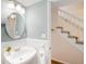Charming powder room featuring a pedestal sink, wainscoting, and a neutral color scheme, near the stairs at 6829 S Niagara Ct, Centennial, CO 80112