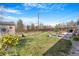 Spacious backyard with green grass, a patio, shed, wood fence, and garden area; perfect for outdoor activities at 5085 E Missouri Ave, Denver, CO 80246