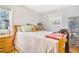 Bright bedroom with hardwood floors, cozy decor, and window with natural light at 5085 E Missouri Ave, Denver, CO 80246