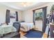 Bedroom with wood floors, a desk area, and large window with backyard view at 5085 E Missouri Ave, Denver, CO 80246