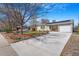 Inviting single-story home with a long driveway and blooming trees at 5085 E Missouri Ave, Denver, CO 80246