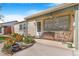 Inviting front porch with colorful flower beds and quaint seating, perfect for enjoying the outdoors at 5085 E Missouri Ave, Denver, CO 80246