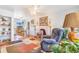 Cozy living room with hardwood floors and a view into the adjacent dining area at 5085 E Missouri Ave, Denver, CO 80246