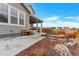 View of the backyard showing the patio, hot tub, and landscaped areas with walkway at 5253 Cherry Blossom Dr, Brighton, CO 80601