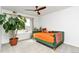 Cheerful bedroom with a colorful bed, a window with neighborhood views, and an indoor tree at 5253 Cherry Blossom Dr, Brighton, CO 80601