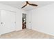 Bright bedroom featuring a ceiling fan, carpeted floors, closet, and adjoining room with neutral paint at 5253 Cherry Blossom Dr, Brighton, CO 80601