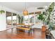 Dining room with modern lighting fixture, wood table with seating, sliding glass doors and view to exterior at 5253 Cherry Blossom Dr, Brighton, CO 80601