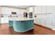 Bright and airy kitchen featuring white cabinets, quartz countertops, and a large island with seating at 5253 Cherry Blossom Dr, Brighton, CO 80601