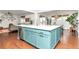 Kitchen island shows stylish, light blue cabinetry, a white countertop, a sink, and stainless steel dishwasher at 5253 Cherry Blossom Dr, Brighton, CO 80601