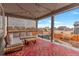 Covered patio with outdoor seating area, bright patterned rug, and scenic neighborhood views at 5253 Cherry Blossom Dr, Brighton, CO 80601