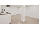 Bright basement featuring a laundry sink, laminate floors, and fresh paint at 3922 W 29Th Ave, Denver, CO 80212