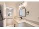 Bathroom with white vanity, modern fixtures, black accents, and a view into the bedroom at 3922 W 29Th Ave, Denver, CO 80212