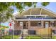 Charming brick home featuring a symmetrical facade, wrought iron fence, and inviting entryway at 3922 W 29Th Ave, Denver, CO 80212