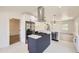 Bright kitchen with stainless steel appliances, a kitchen island, and herringbone-patterned flooring at 3922 W 29Th Ave, Denver, CO 80212