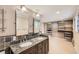 Spacious bathroom with double vanity, granite countertop, and custom closet at 6259 S Fenton Ct, Littleton, CO 80123