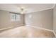 Bright bedroom with light wood floors, ceiling fan, and large window at 6259 S Fenton Ct, Littleton, CO 80123