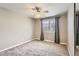 Neutral bedroom featuring a ceiling fan and a window with privacy curtains at 6259 S Fenton Ct, Littleton, CO 80123