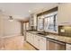 Updated kitchen featuring granite countertops and stainless steel dishwasher at 6259 S Fenton Ct, Littleton, CO 80123