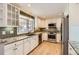 Updated kitchen featuring granite countertops, stainless steel appliances and white cabinets at 6259 S Fenton Ct, Littleton, CO 80123