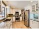 Modern kitchen with stainless steel appliances, granite countertops and white cabinets at 6259 S Fenton Ct, Littleton, CO 80123