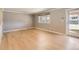 Light-filled room with hardwood floors and a sliding glass door to the exterior at 6259 S Fenton Ct, Littleton, CO 80123