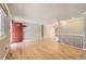 Bright living room features hardwood floors and a red front door at 6259 S Fenton Ct, Littleton, CO 80123