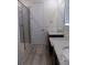 Elegant bathroom with double sink granite vanity, walk-in shower, and contemporary fixtures at 1154 E Witherspoon Dr, Elizabeth, CO 80107