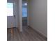 Inviting entryway with stylish light wood-look floors and a bright front door, leading to additional living spaces at 1154 E Witherspoon Dr, Elizabeth, CO 80107