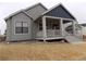 Rear view of home showing well-maintained siding and a covered patio area at 1154 E Witherspoon Dr, Elizabeth, CO 80107