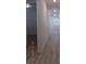 Hallway with wood-look flooring, clean lines, and access to multiple rooms at 1154 E Witherspoon Dr, Elizabeth, CO 80107