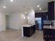 Contemporary kitchen featuring stainless steel appliances, dark cabinets, and a functional kitchen island at 1154 E Witherspoon Dr, Elizabeth, CO 80107