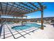 Community pool featuring lounge chairs, tables, and a wooden pergola at 1154 E Witherspoon Dr, Elizabeth, CO 80107