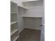Spacious walk-in closet featuring built-in shelving and rod space for organized storage solutions at 1154 E Witherspoon Dr, Elizabeth, CO 80107
