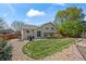 Backyard featuring a patio, landscaped yard, and well-maintained lawn at 11296 Daisy Ct, Firestone, CO 80504