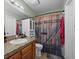 Bathroom featuring granite countertop, wood-themed shower curtain, and modern fixtures at 11296 Daisy Ct, Firestone, CO 80504
