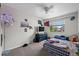 Neutral bedroom with ceiling fan, window views, and ample space at 11296 Daisy Ct, Firestone, CO 80504