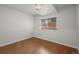 Clean, minimalist bedroom with hardwood floors and a window providing natural light at 11296 Daisy Ct, Firestone, CO 80504