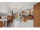 Cozy dining area with an adjacent island with bar seating and kitchen access to the back yard at 11296 Daisy Ct, Firestone, CO 80504