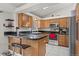 Well-lit kitchen featuring granite countertops, stainless steel appliances, and wood cabinets at 11296 Daisy Ct, Firestone, CO 80504