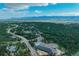 Aerial view of a neighborhood with community pool nestled among mature trees and winding roads at 17865 Smugglers Rd, Monument, CO 80132