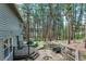 Spacious backyard with mature trees, deck, and outdoor seating area at 17865 Smugglers Rd, Monument, CO 80132
