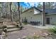 Landscaped backyard featuring multiple seating areas, stairs, and mature trees at 17865 Smugglers Rd, Monument, CO 80132
