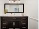 Modern bathroom with a large vanity, quartz countertops, and modern lighting at 17865 Smugglers Rd, Monument, CO 80132