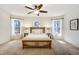 Light-filled bedroom with neutral tones, large windows, and ceiling fan at 17865 Smugglers Rd, Monument, CO 80132