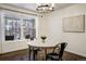 Bright dining room with large windows, modern light fixture, and hardwood floors at 17865 Smugglers Rd, Monument, CO 80132
